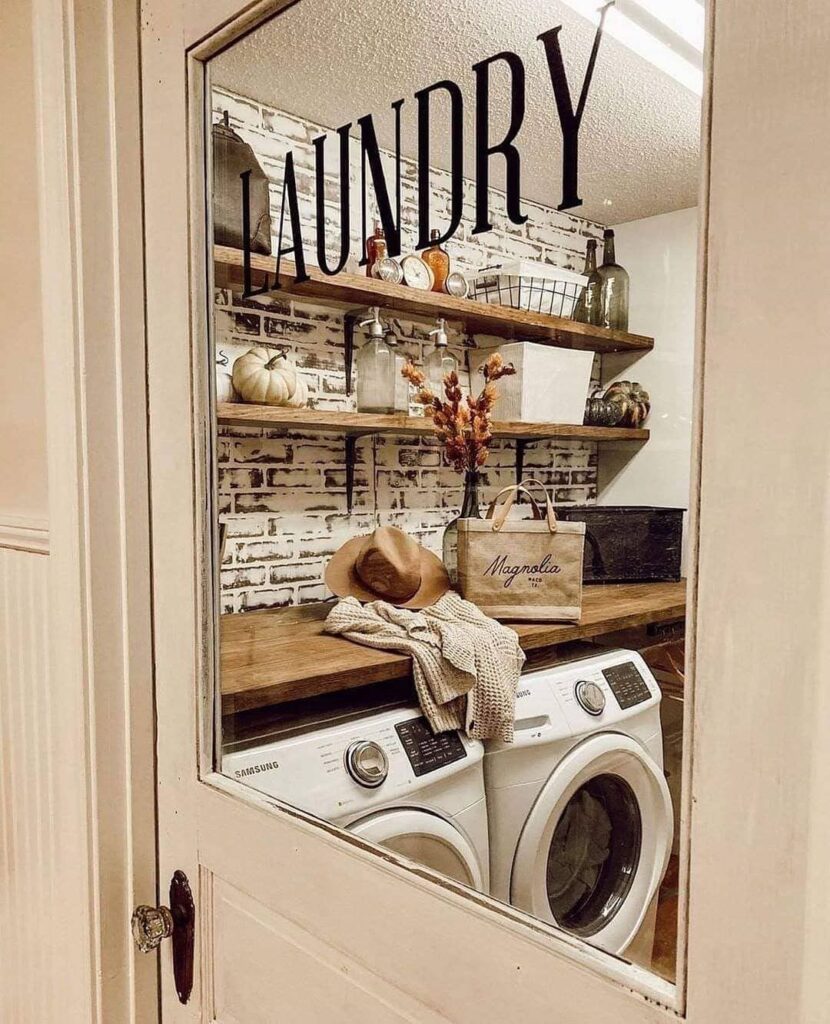 Laundry room with rustic decor, brick wall, and modern appliances.