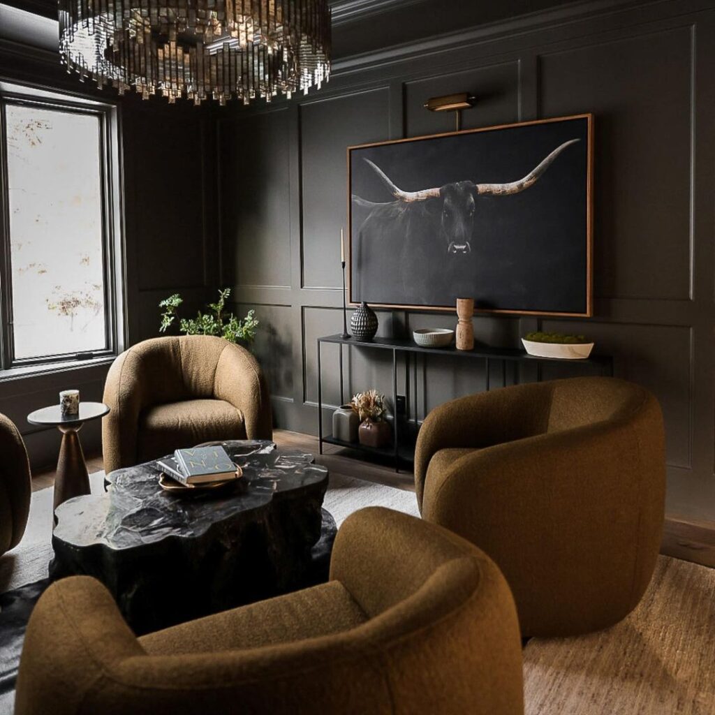 Dark living room with brown chairs and bull artwork