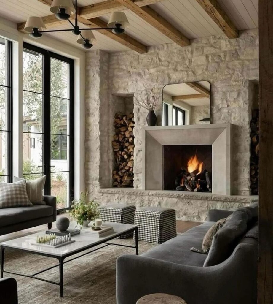 Rustic living room with stone fireplace, wooden beams, and modern furniture.