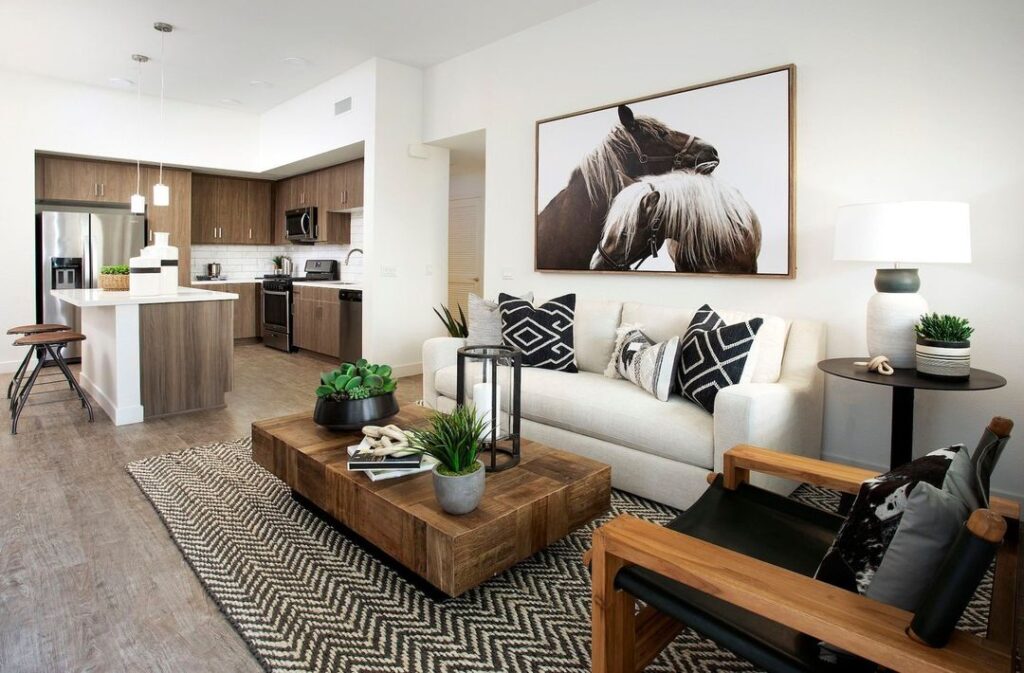 Open concept living room with horse art and wooden accents