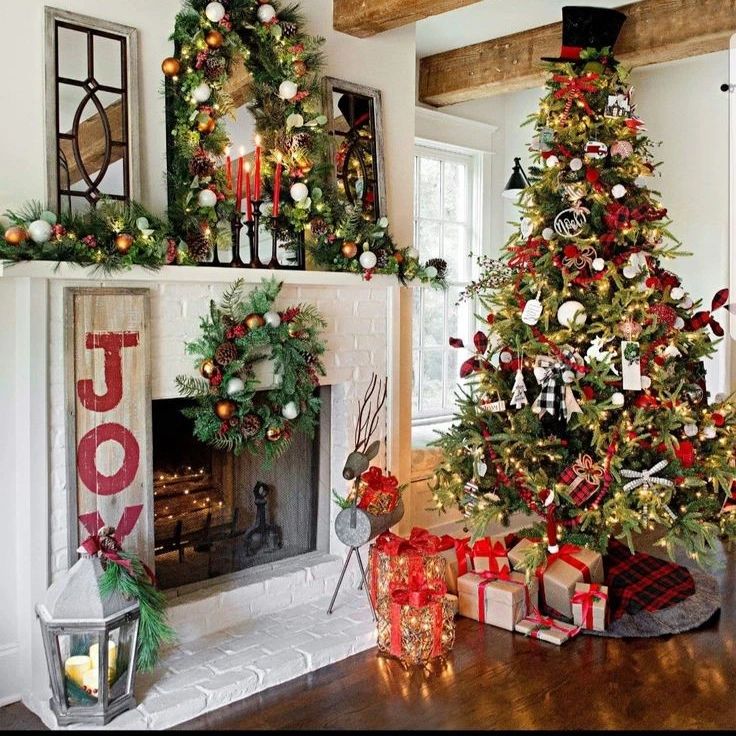 Farmhouse Christmas tree beside fireplace with JOY sign and rustic decorations