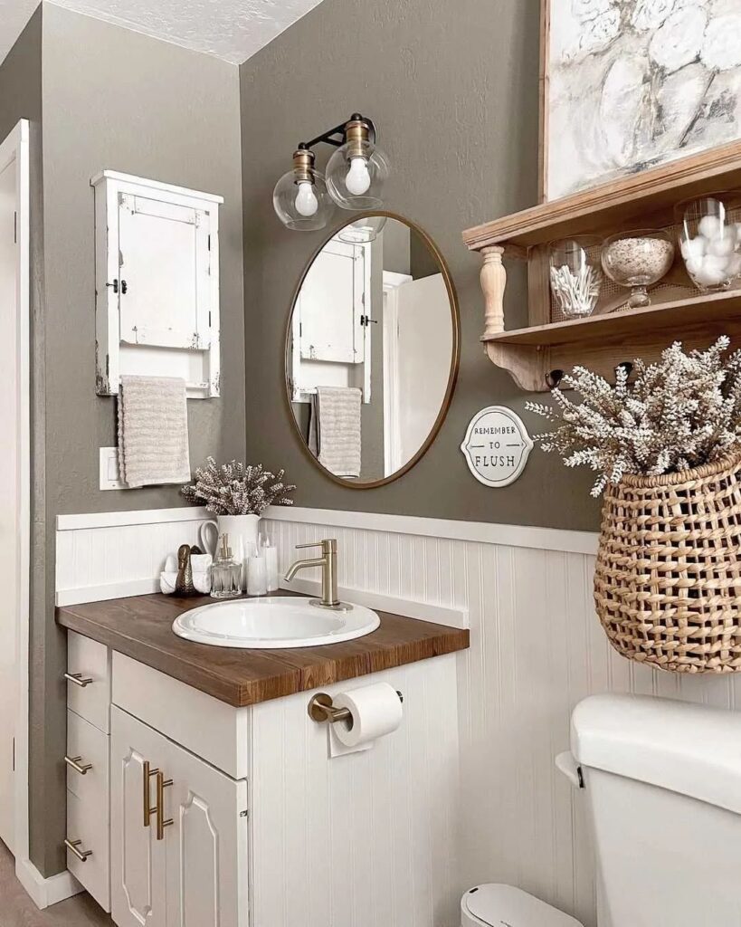 Cozy bathroom with taupe walls wooden vanity and fall decor