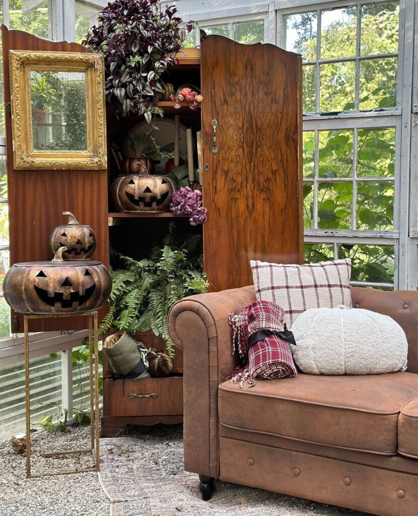 Sunroom with rustic decor and Halloween pumpkins.