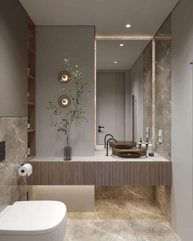 Minimalist gray bathroom with marble accents and wooden vanity.