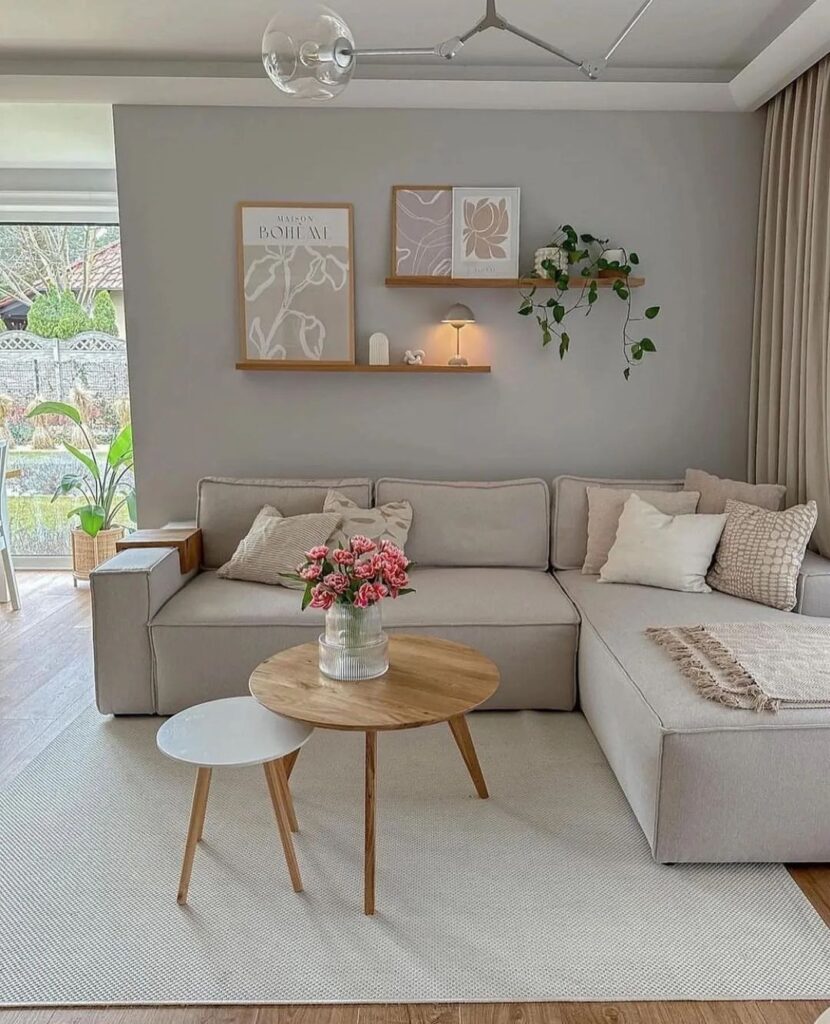 Neutral living room with grey sectional wooden accents and modern decor