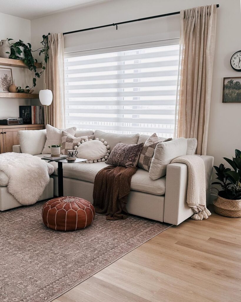 Cozy living room with cream sofa layered textures and soft lighting.