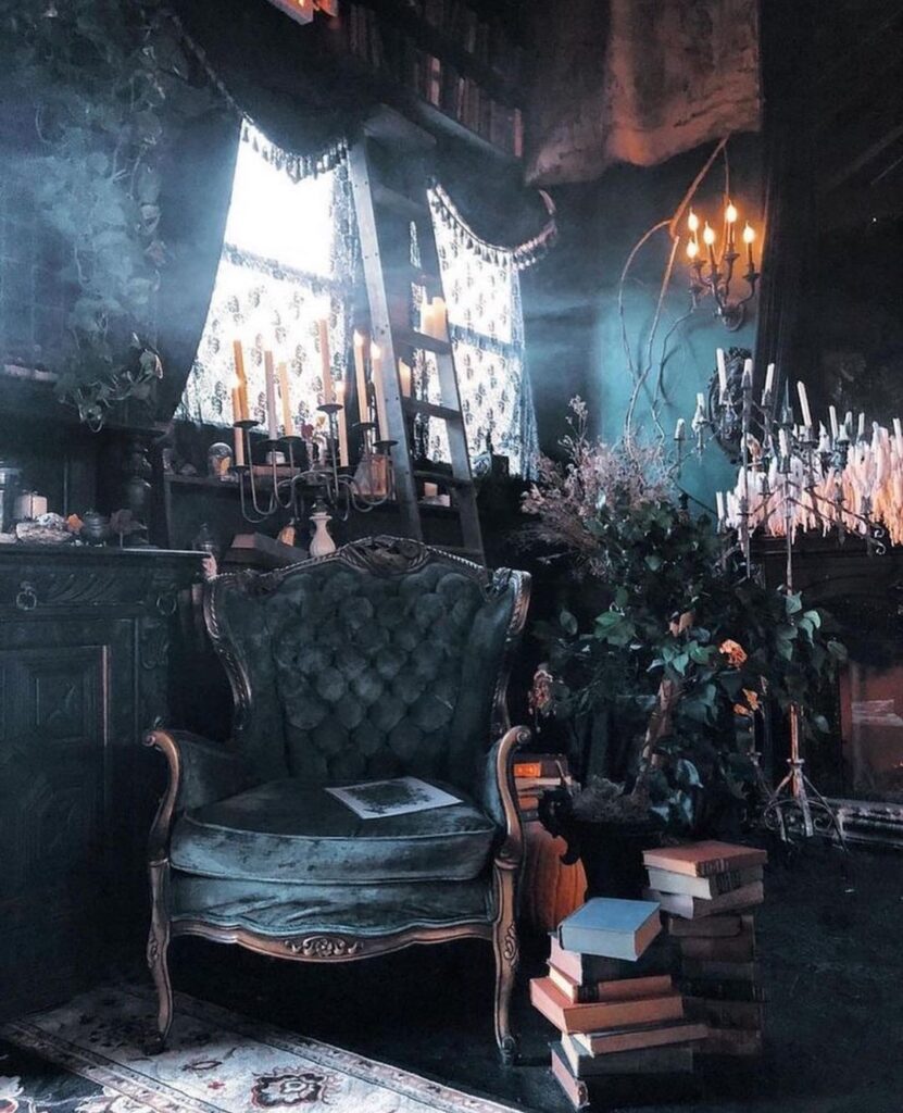 Dimly lit witchy room with vintage chair and candles.