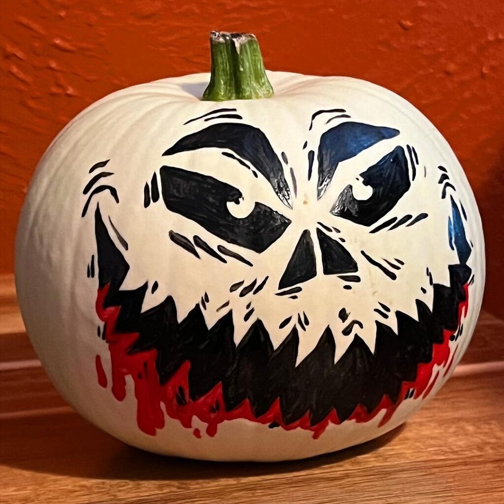 Jack Skellington face painted on white pumpkin
