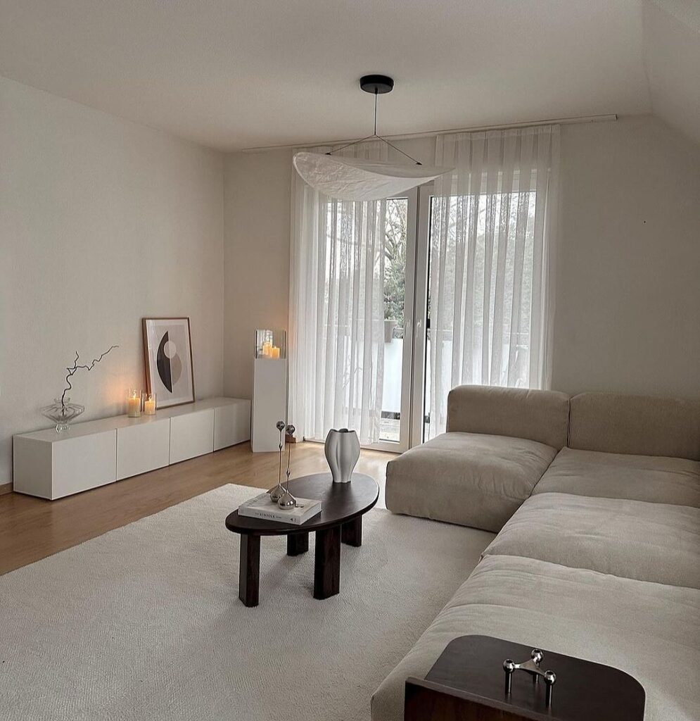 Minimalist living room with white decor and large windows