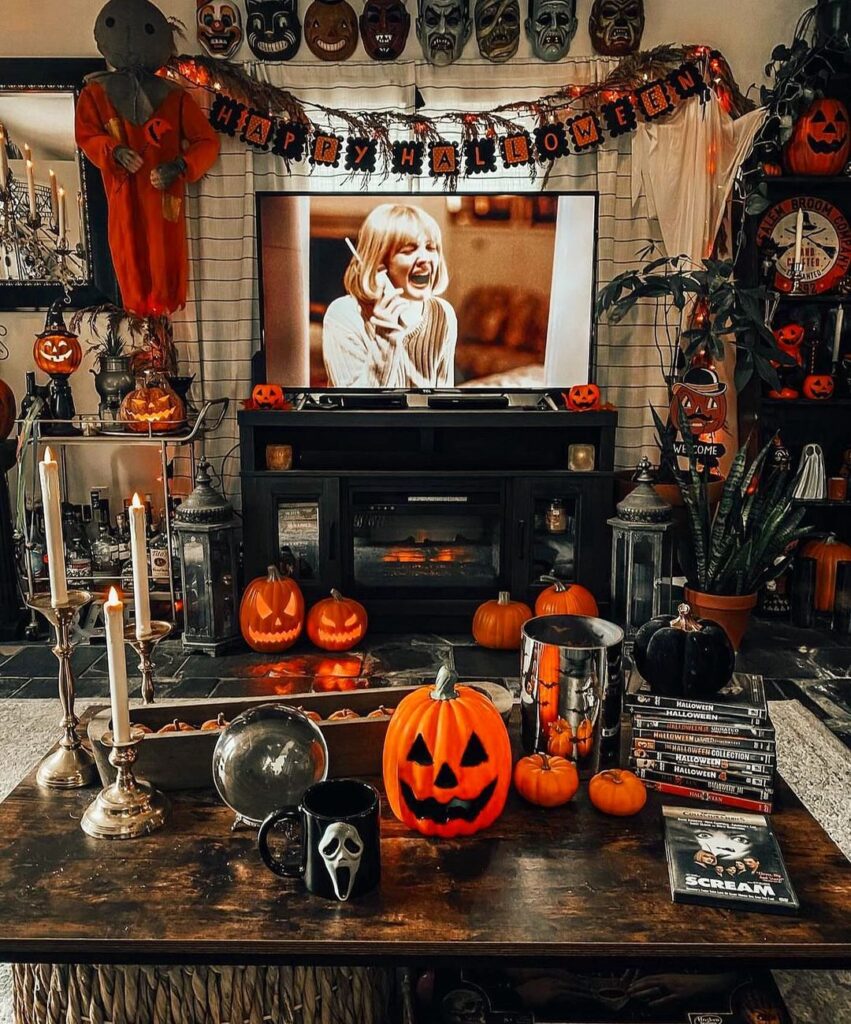 Halloween-themed room with horror movie decor and pumpkins