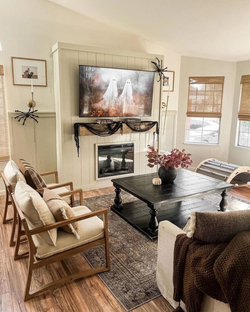 Living room with ghostly TV display and subtle Halloween decor.