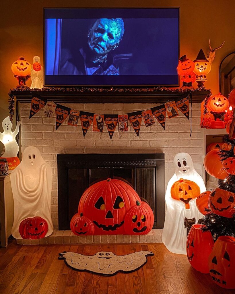 Halloween decorated fireplace with movie and decorations