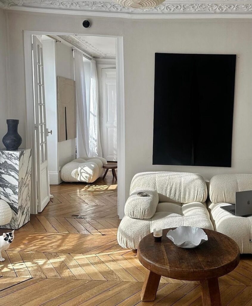 Bright living room with white sofa and herringbone floors