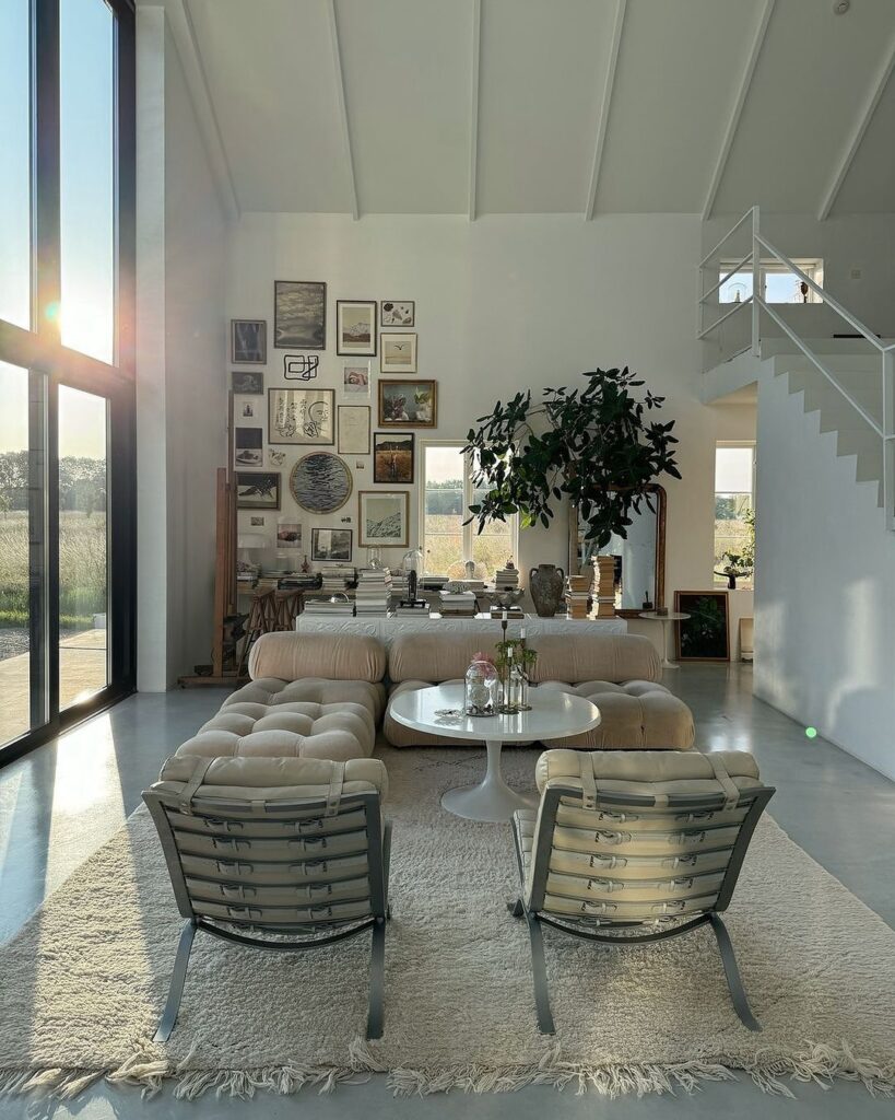 Sunlit modern living room with gallery wall.