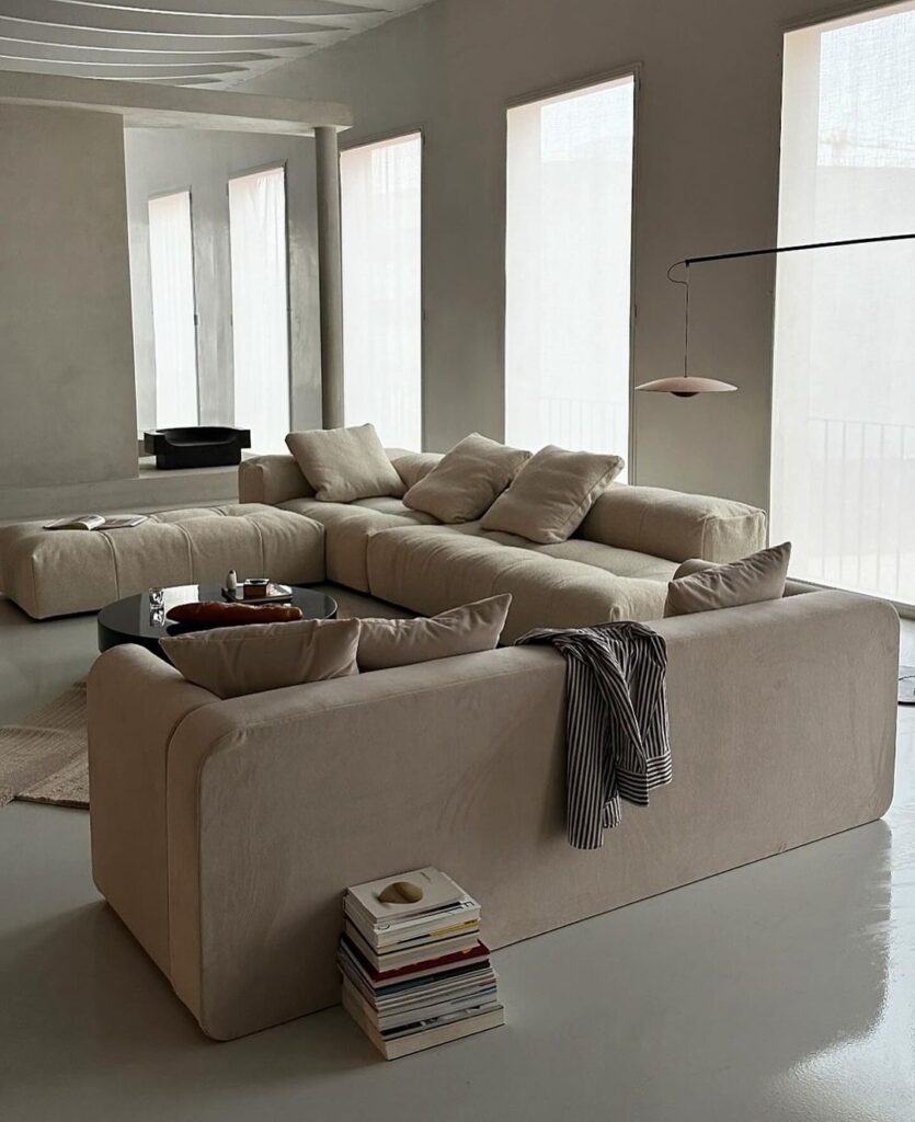 Minimalist living room with large beige sectional sofa