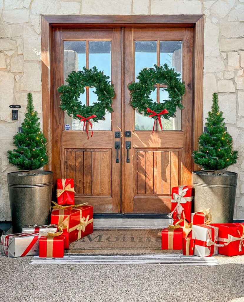 Double wooden doors with matching wreaths and wrapped gifts