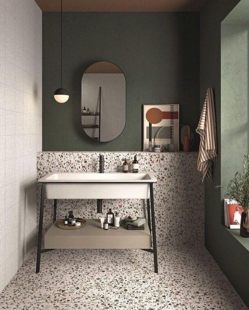 Modern bathroom with sage walls, terrazzo floors, and minimalist fixtures.