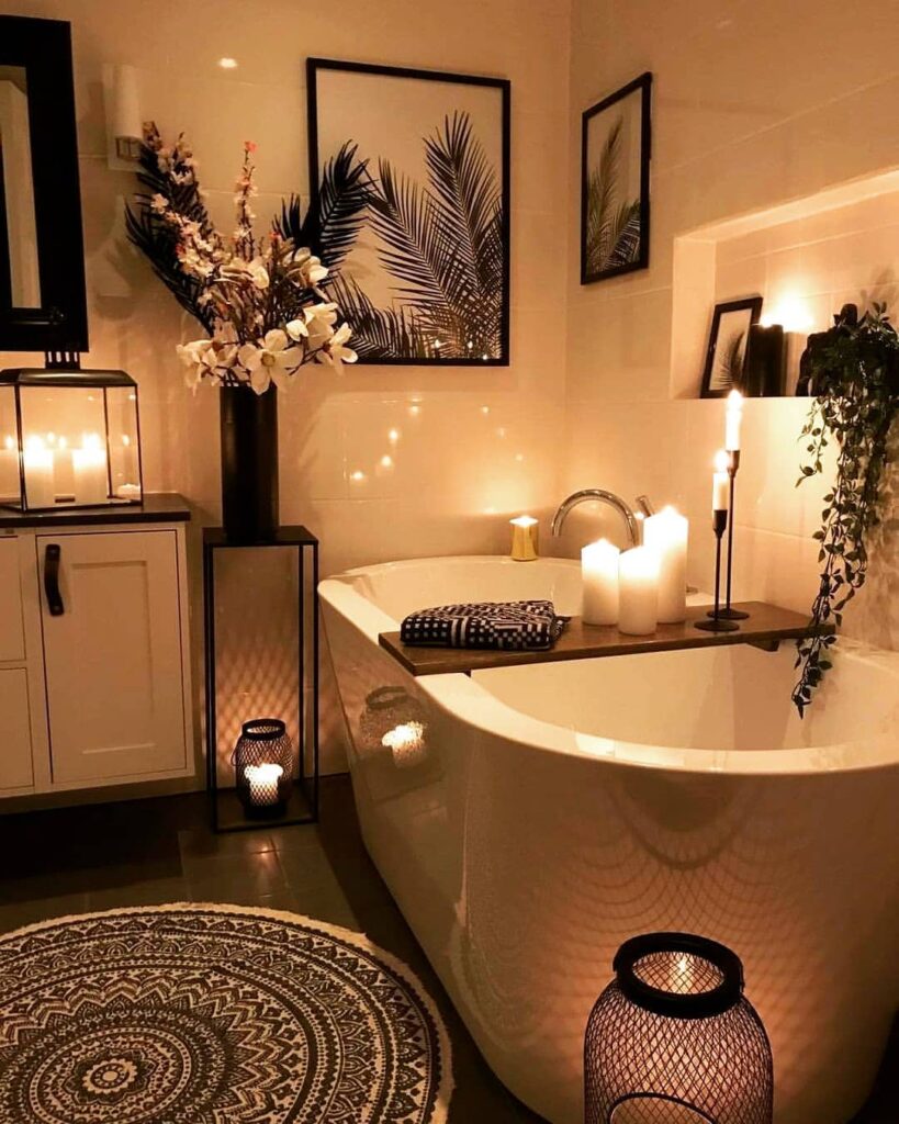 Candlelit bathroom with tropical decor and freestanding tub.