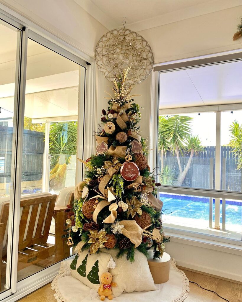 Rustic Christmas tree with tropical outdoor view.