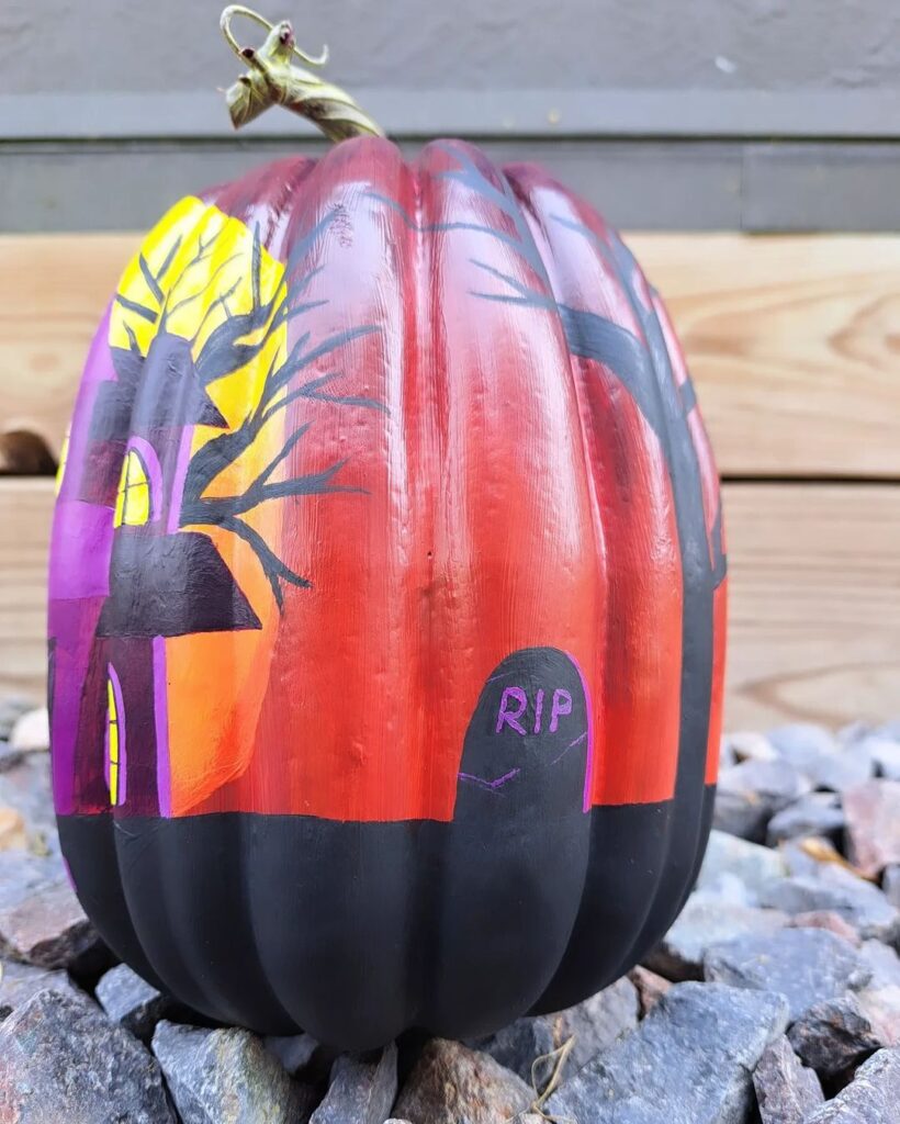 Pumpkin painted with twilight graveyard scene.
