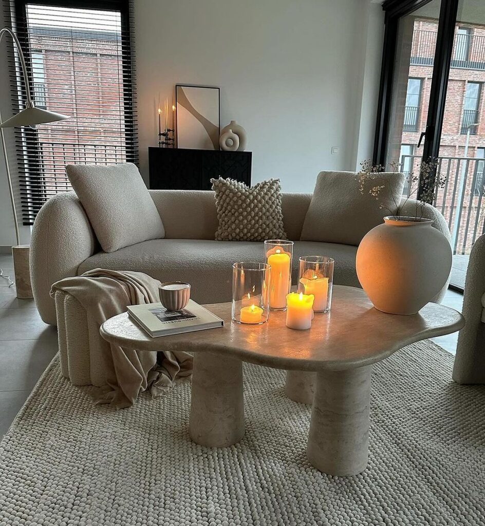 Cozy urban living room with candles and curved furniture