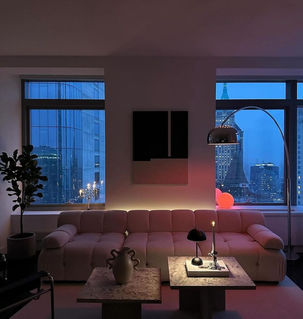 Cozy living room with city skyline view at dusk