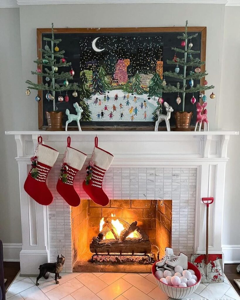 "Christmas mantel with chalkboard winter scene, stockings, and crackling fireplace"