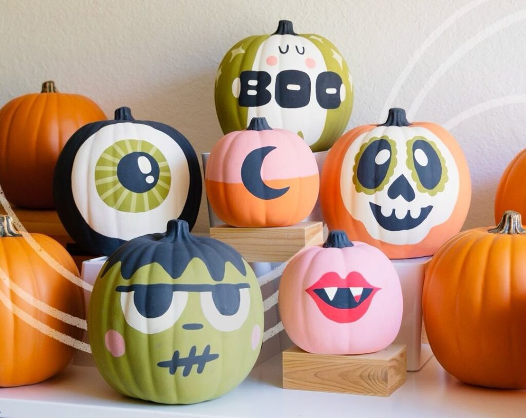 Colorful painted pumpkins with cute Halloween faces.