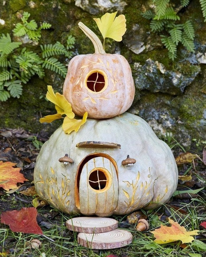 Pumpkins carved into fairy house in forest