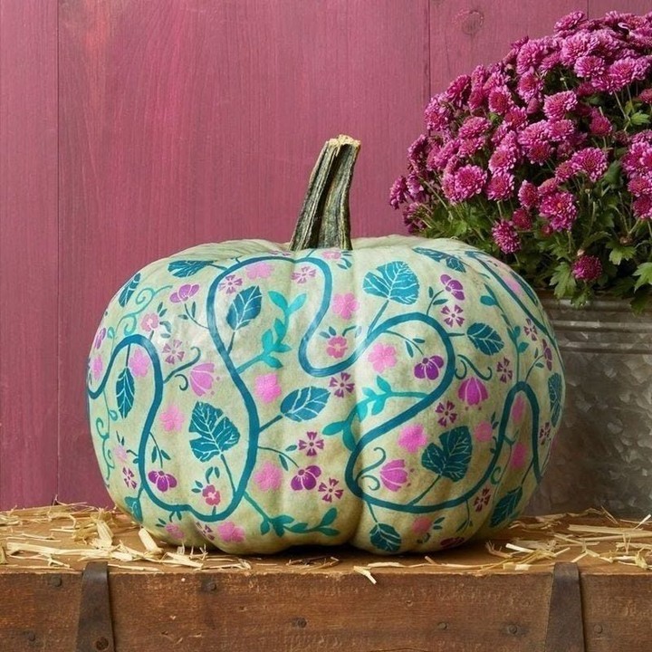 Pastel pumpkin painted with colorful floral design.