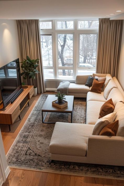 Small living room with large windows overlooking snowy trees