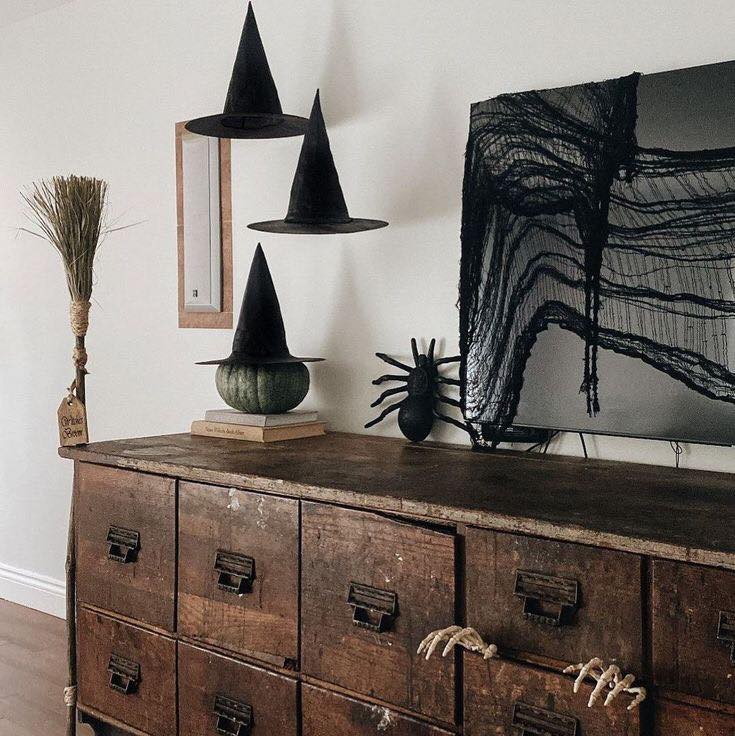 Antique cabinet with witch hats spider broom