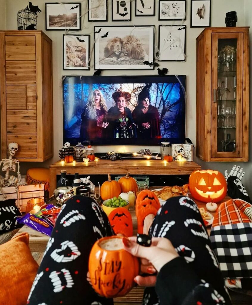 Halloween-themed room with witchy movie and spooky decor