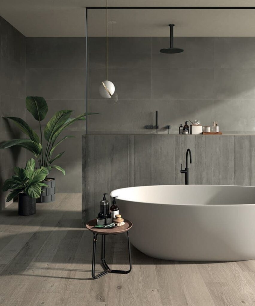 Small gray bathroom with freestanding tub and plants