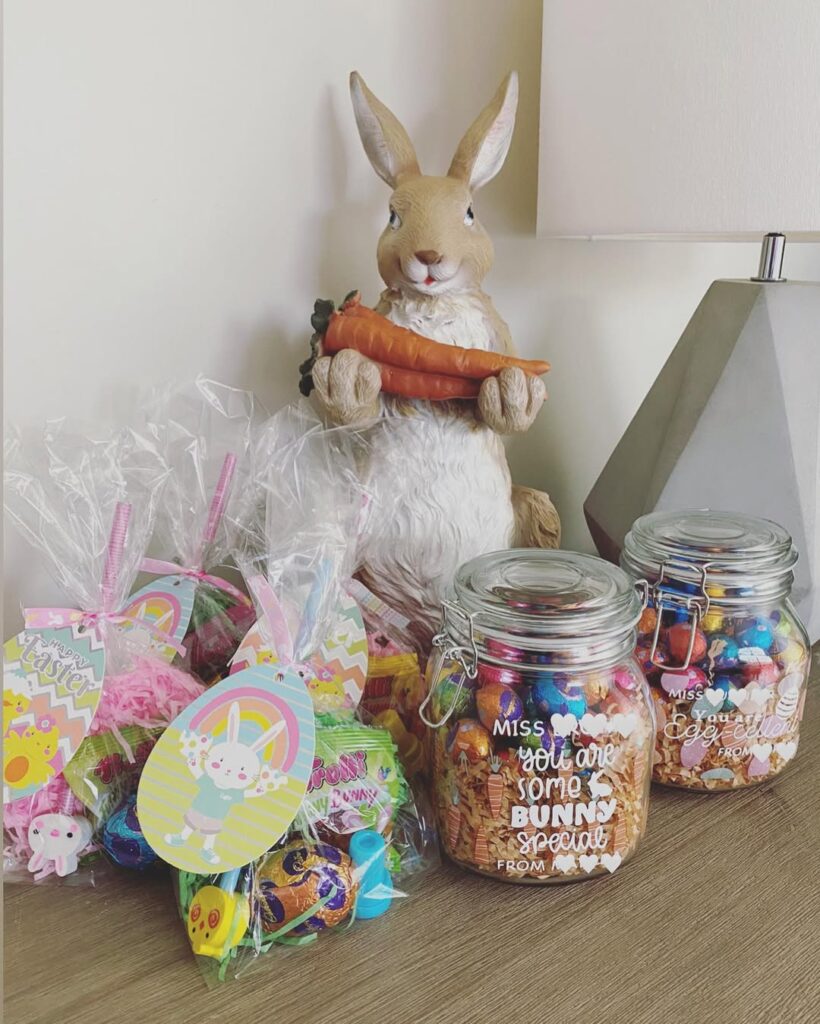 Easter themed mason jars with bunny decorations and colorful candy treats