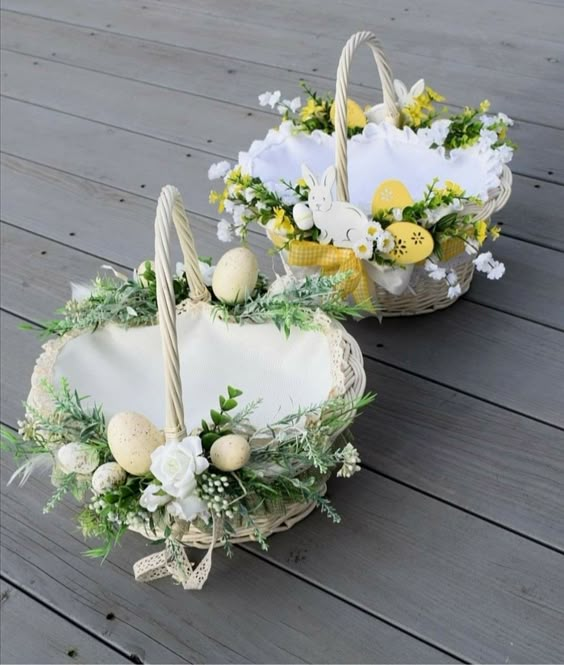 Two white wicker Easter baskets decorated with flowers eggs and greenery