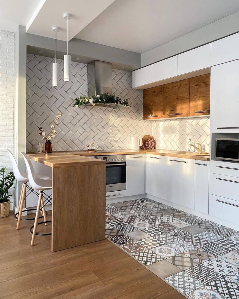 L-shaped kitchen with herringbone backsplash and geometric floor tiles