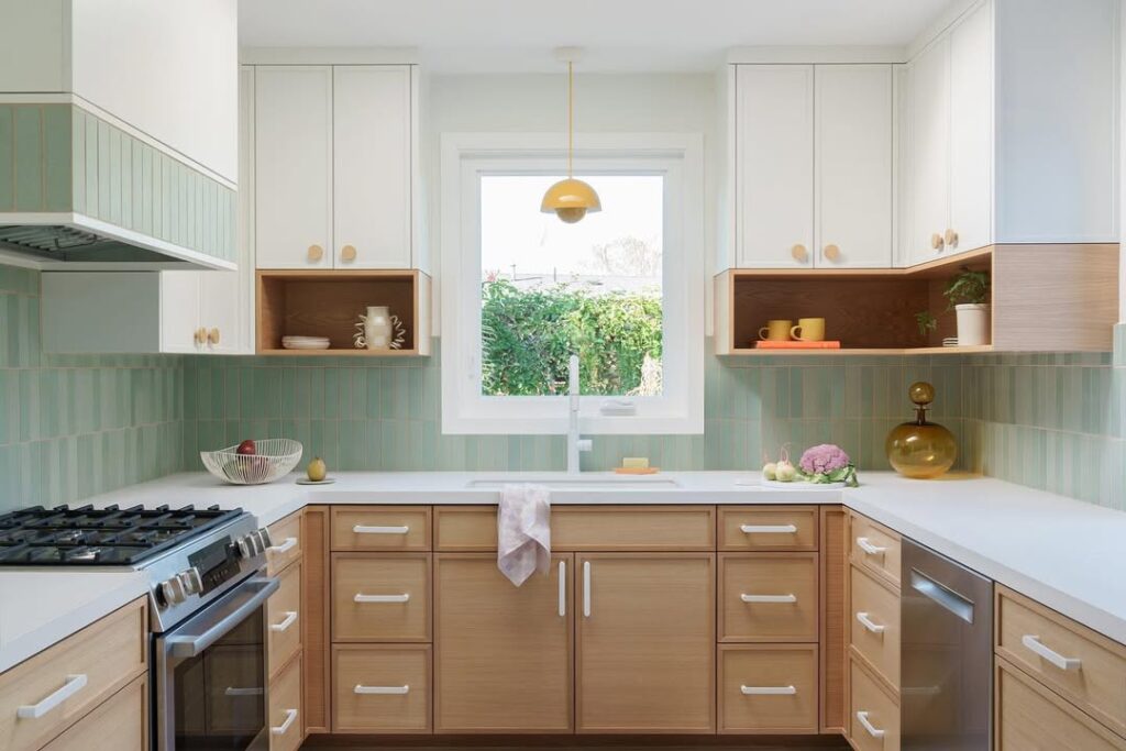 Modern kitchen with sage green tiles and natural wood cabinets