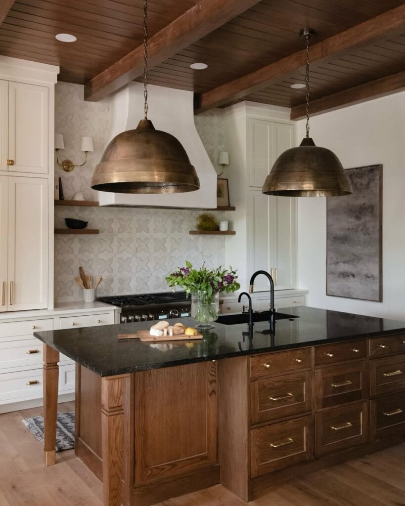 Kitchen with copper pendants wooden island and patterned backsplash