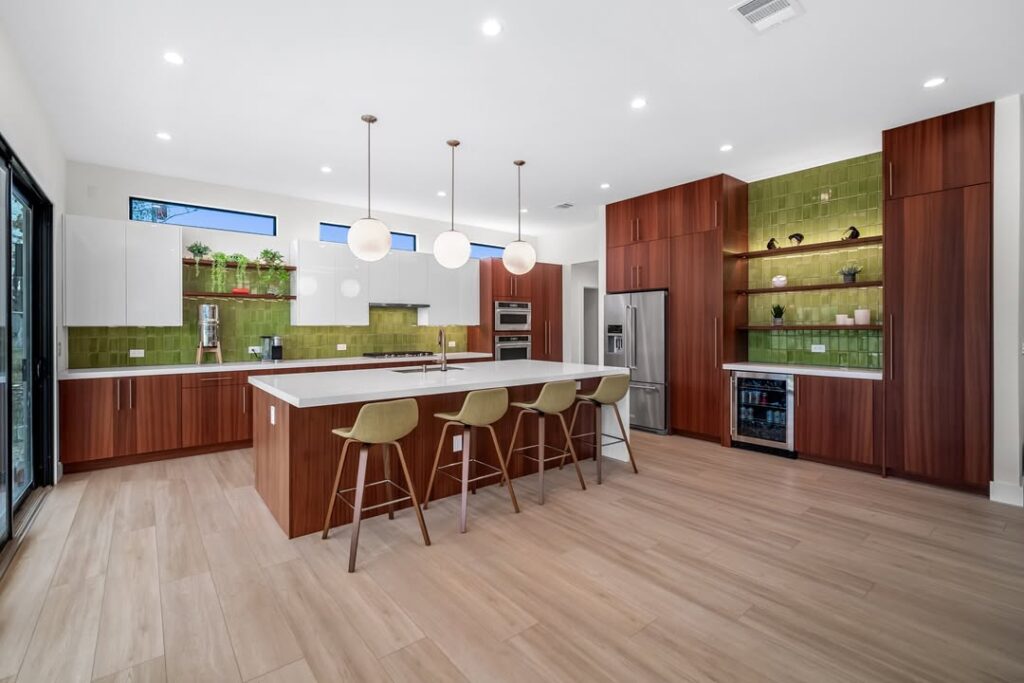 Modern kitchen featuring green tile and mahogany cabinets