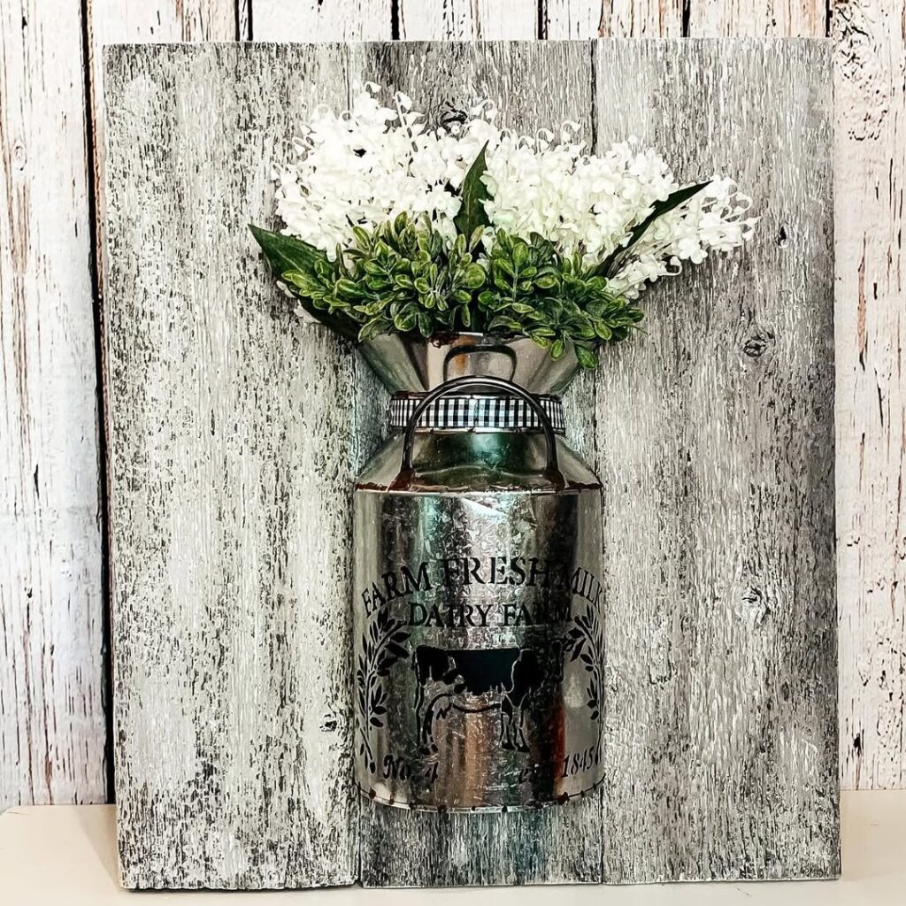 Silver dairy farm milk can with hydrangeas on weathered wood backdrop