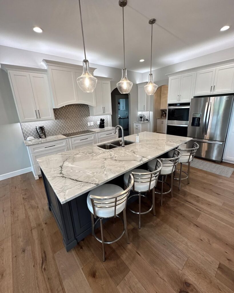 Modern kitchen with glass pendants and arabesque tile backsplash