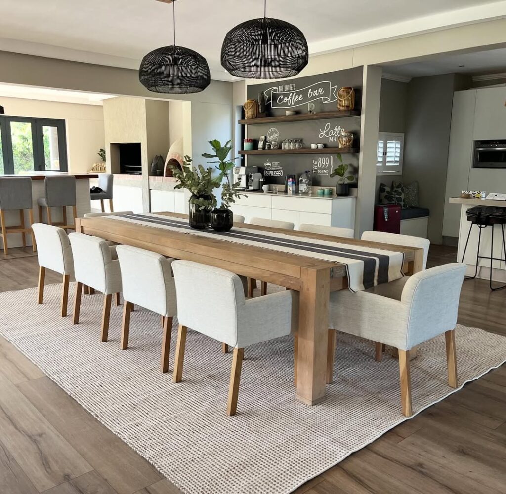  Kitchen with coffee bar featuring black pendant lights and wooden table