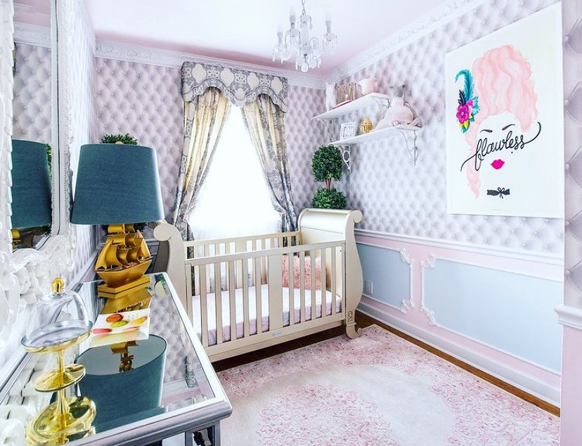 Elegant nursery with tufted walls sleigh crib crystal chandelier and pink accents