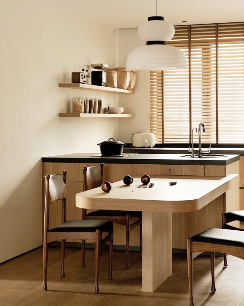 Small kitchen with curved dining table and modern pendant light