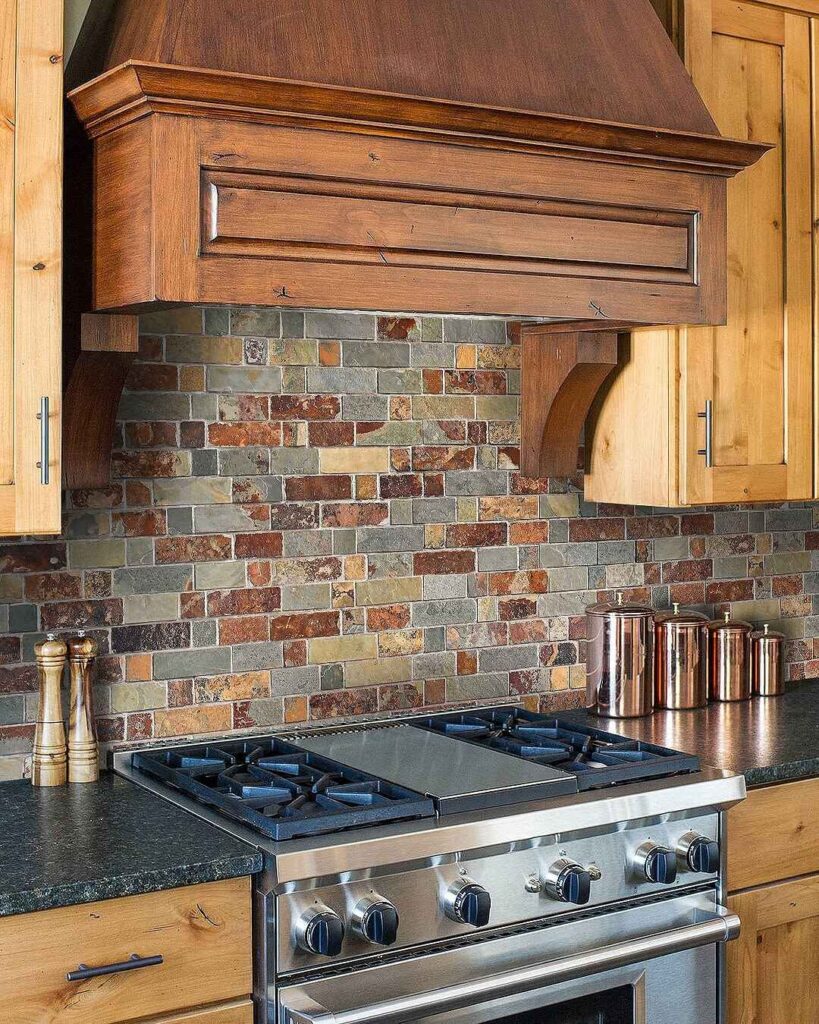 Rustic kitchen with stone tile backsplash and wooden range hood