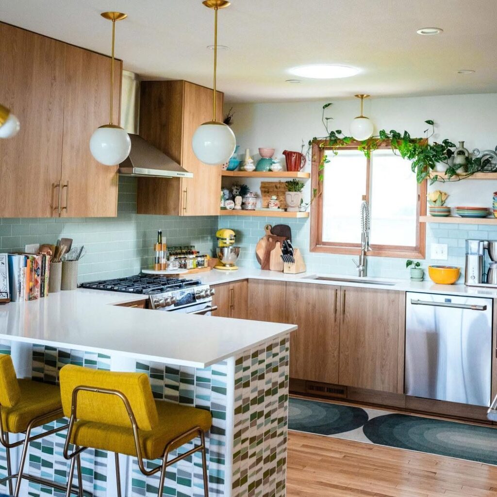 Kitchen with mint tiles yellow chairs and globe lights