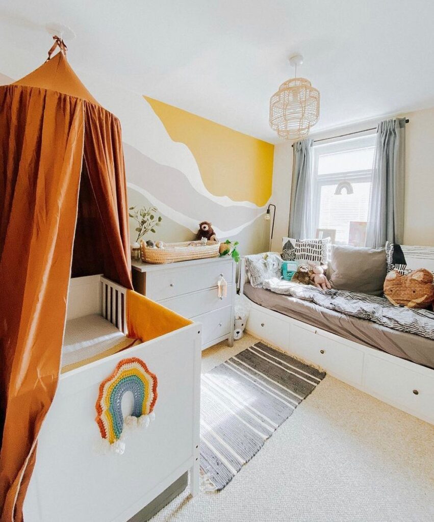 Children's room with mountain mural rust canopy and built-in daybed with rainbow decor