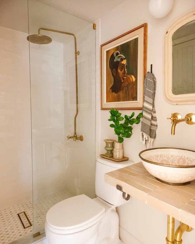  Modern bathroom with brass fixtures and artistic accents