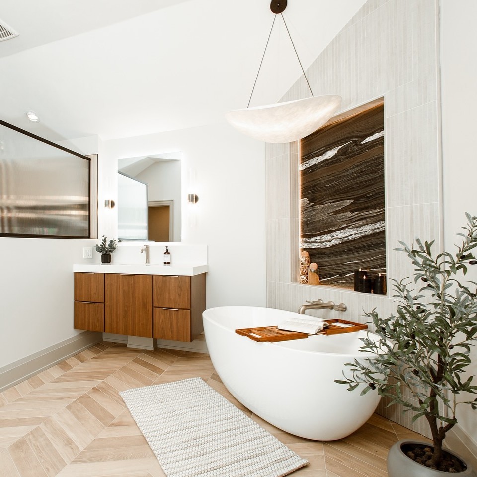 Modern bathroom with wooden vanity and marble accent wall